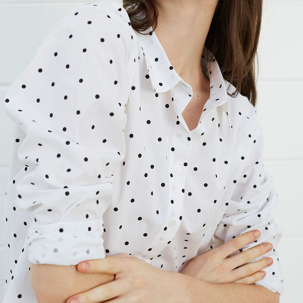 Close up of woman wearing polka dot shirt
