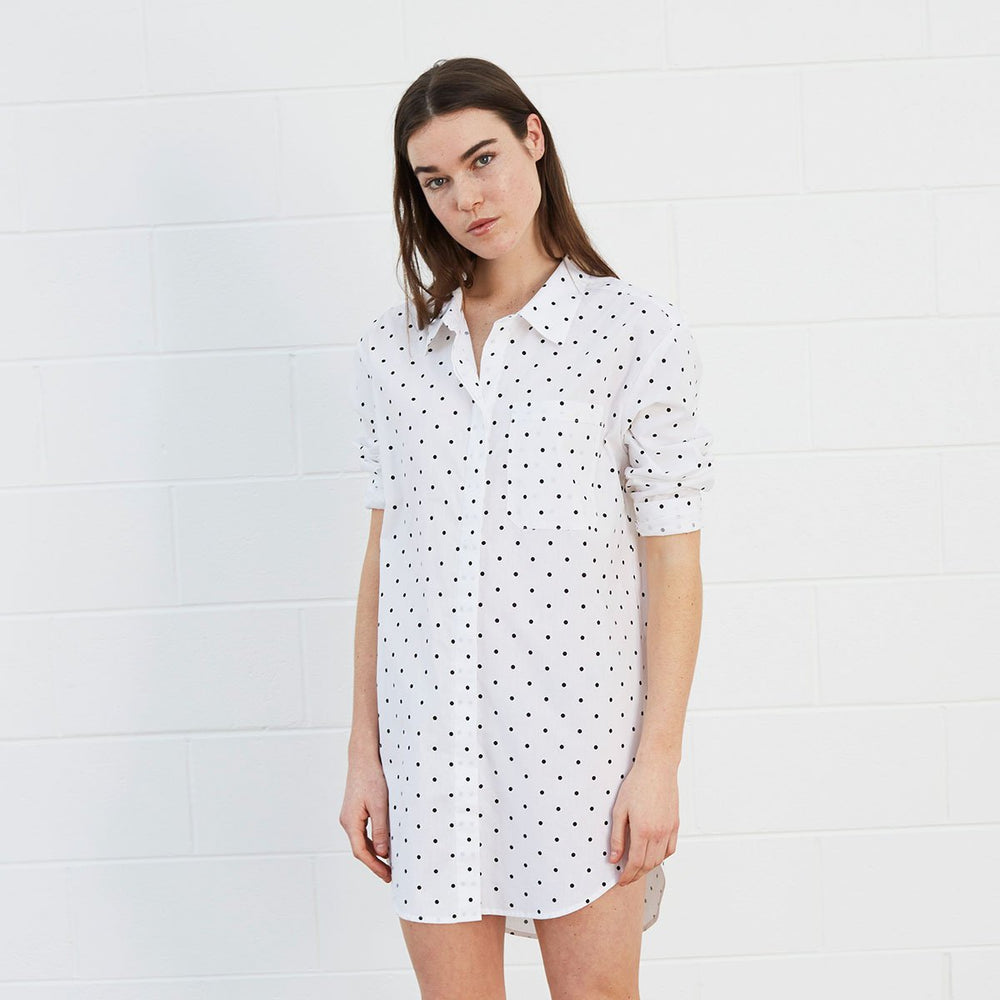 Woman wearing polka dot shirt dress