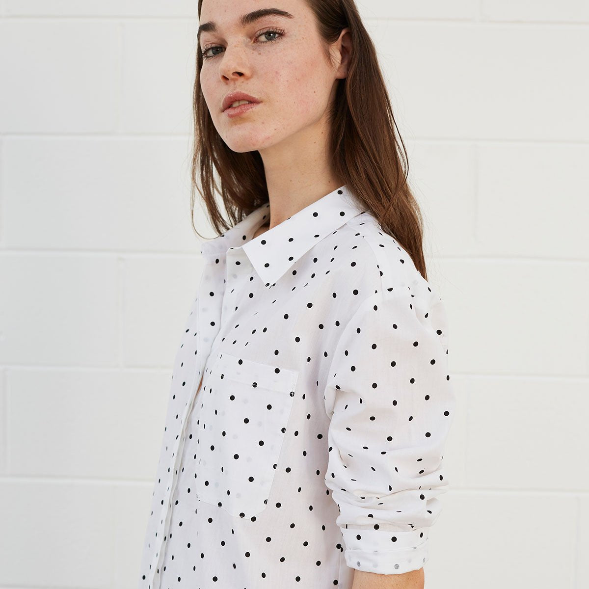 Woman wearing polka dot shirt dress