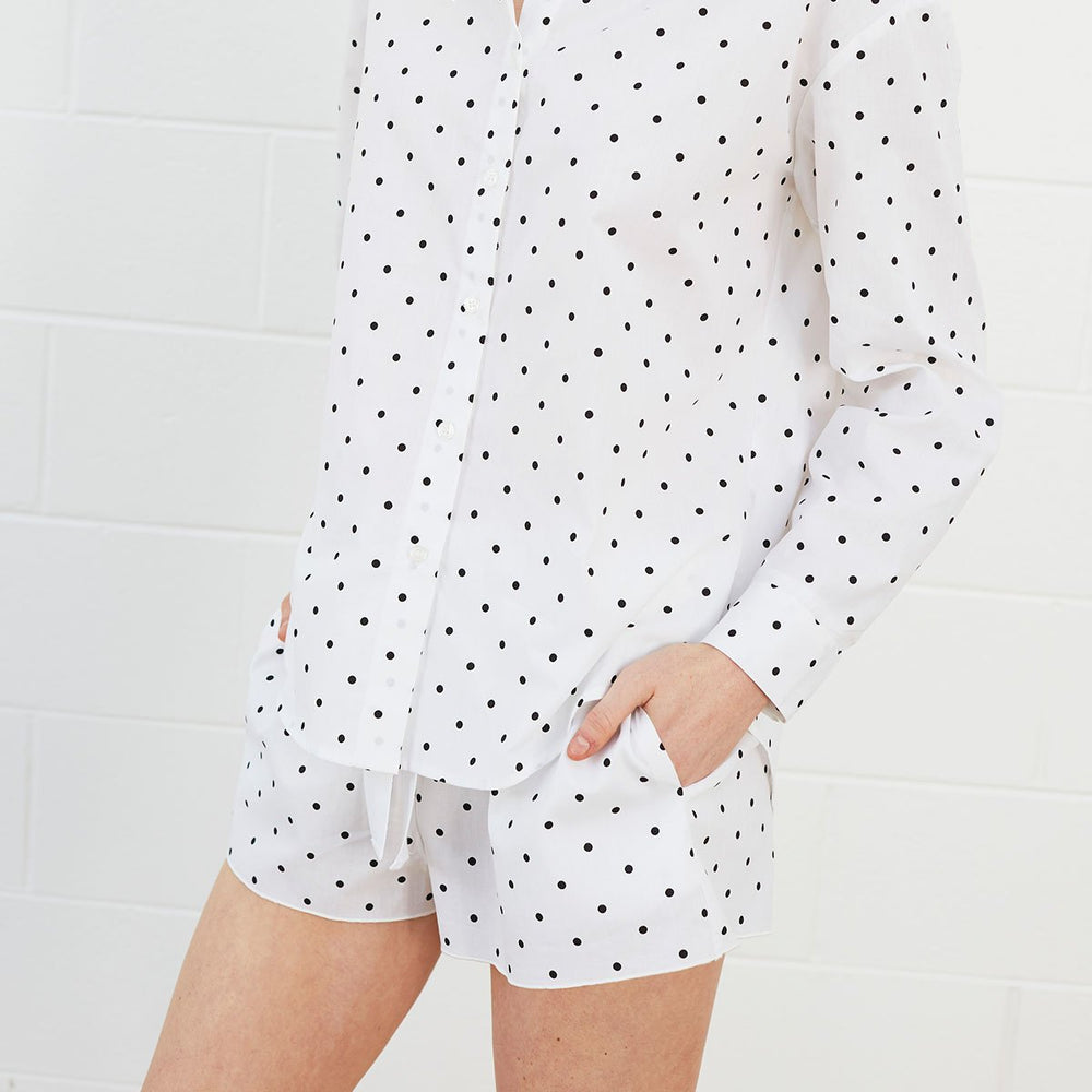 
                  
                    Woman wearing polka dot shirt and shorts
                  
                