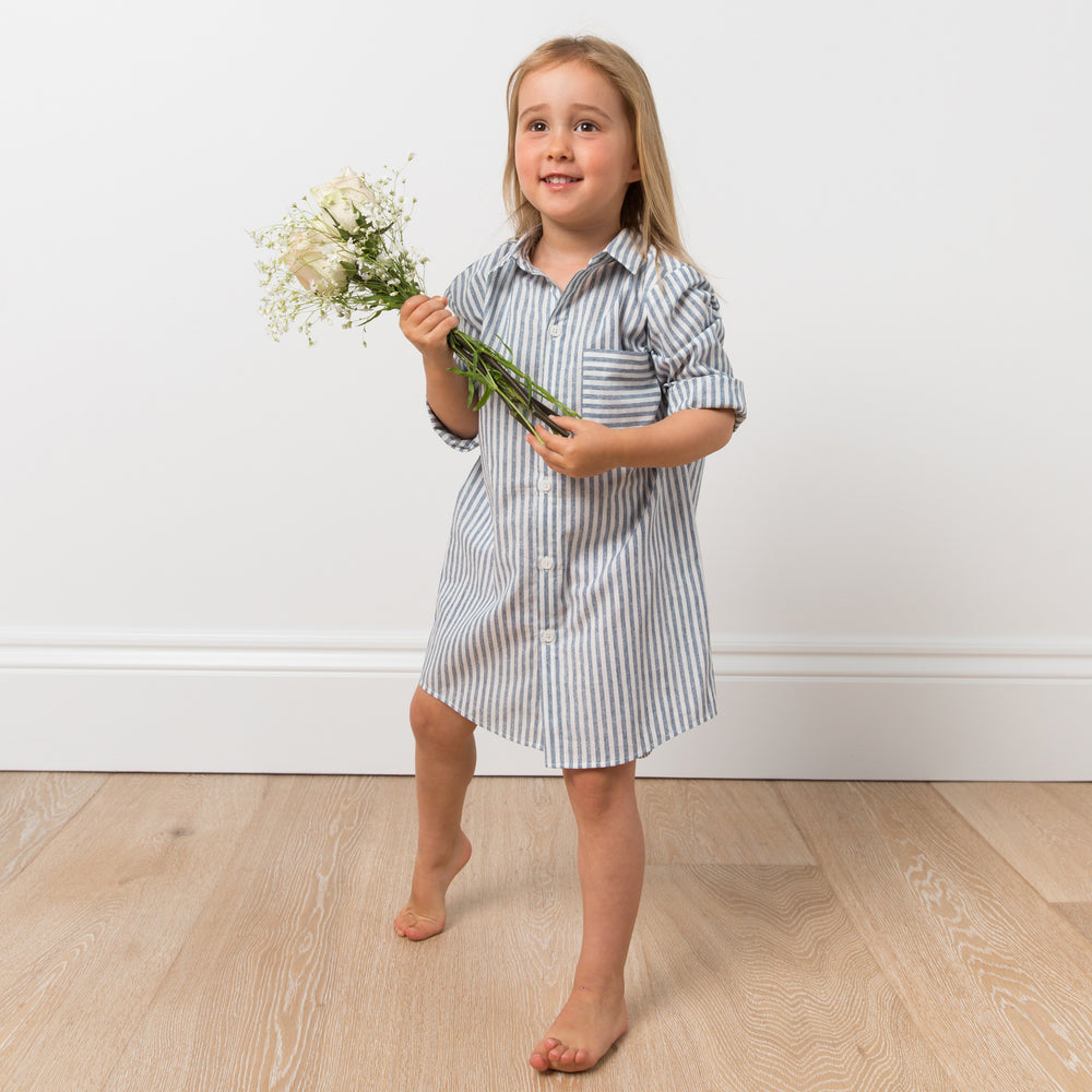 Girl wearing striped shirt dress with flowers