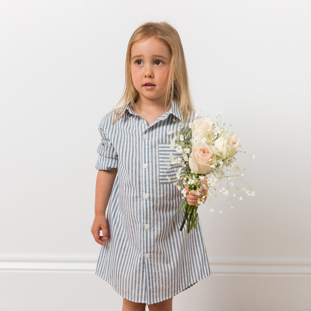 
                  
                    Girl wearing striped shirt dress with flowers
                  
                