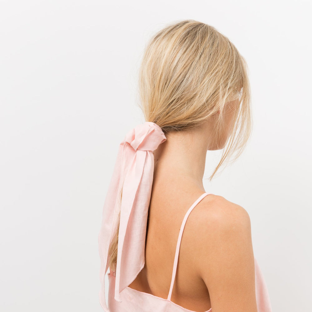 Woman wearing pink scarf in hair